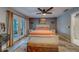 Serene primary bedroom offering a comfortable bed, bench seating, and views to an outdoor patio, creates a private retreat at 9802 Eden Ave, Hudson, FL 34667