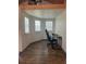 Bright office space with three windows, wood-look floors, and a lofted storage area at 9802 Eden Ave, Hudson, FL 34667
