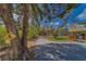 A quaint street view features a charming property with mature trees and a 'Chicken Xing' sign at 9802 Eden Ave, Hudson, FL 34667