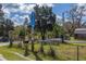 A street view showcases a property's address marker, mailbox, and fence, surrounded by trees at 9802 Eden Ave, Hudson, FL 34667