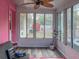 Enclosed sunroom with large windows and vinyl flooring offering a relaxing space at 9802 Eden Ave, Hudson, FL 34667