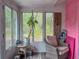 Bright sunroom with large windows offering plenty of natural light and views of the surrounding landscape at 9802 Eden Ave, Hudson, FL 34667