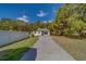 Exterior view of the home and yard showing mature trees and greenery at 9802 Eden Ave, Hudson, FL 34667