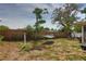 Spacious fenced backyard featuring a hammock and swing set, perfect for outdoor relaxation and play at 9836 Rainbow Ln, Port Richey, FL 34668