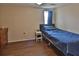 Cozy bedroom featuring blue bedding, wood floors, and ample closet space at 9836 Rainbow Ln, Port Richey, FL 34668