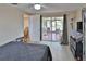 Neutral bedroom with access to outdoor patio with sliding glass door and ceiling fan at 9836 Rainbow Ln, Port Richey, FL 34668