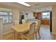 Well-lit dining area with a view to the kitchen, perfect for casual meals and gatherings at 9836 Rainbow Ln, Port Richey, FL 34668