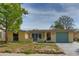 Charming single-story home featuring a well-lit exterior and a neatly maintained front yard at 9836 Rainbow Ln, Port Richey, FL 34668
