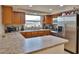 Well-lit kitchen featuring modern appliances, a double sink, and plenty of counter space at 9836 Rainbow Ln, Port Richey, FL 34668