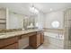 The bathroom has a soaking tub, a glass-enclosed shower, and a marble countertop at 10144 Arbor Run Dr # 157, Tampa, FL 33647
