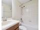 An interior shot of a bathroom, featuring a white tiled shower and a cream sink and vanity at 10144 Arbor Run Dr # 157, Tampa, FL 33647