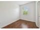 Bedroom with a window and wood floors at 10144 Arbor Run Dr # 157, Tampa, FL 33647
