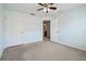 Bedroom featuring two doors, neutral carpet, ceiling fan, and ample natural light at 10144 Arbor Run Dr # 157, Tampa, FL 33647