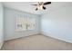 Bright bedroom with a ceiling fan and a large window bringing in natural light at 10144 Arbor Run Dr # 157, Tampa, FL 33647