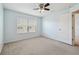 Comfortable bedroom featuring a ceiling fan and a window offering natural light, door access at 10144 Arbor Run Dr # 157, Tampa, FL 33647