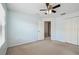 This is a carpeted bedroom with light blue walls, a ceiling fan, and access to a closet at 10144 Arbor Run Dr # 157, Tampa, FL 33647