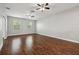 Large bedroom with wood floors, two windows and ceiling fans at 10144 Arbor Run Dr # 157, Tampa, FL 33647