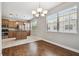 Dining area with wood flooring, natural light, and adjacent to a modern kitchen at 10144 Arbor Run Dr # 157, Tampa, FL 33647
