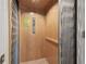 Interior view of a home elevator with metal folding gate and wood paneled walls at 10144 Arbor Run Dr # 157, Tampa, FL 33647