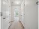 Well-lit hallway with neutral carpet and white doors offering access to multiple rooms at 10144 Arbor Run Dr # 157, Tampa, FL 33647