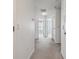 Hallway with carpet, white walls, and doors leading to bedrooms and other living areas at 10144 Arbor Run Dr # 157, Tampa, FL 33647