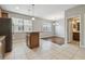 Bright kitchen features a center island, tile flooring, pendant lights and ample natural light at 10144 Arbor Run Dr # 157, Tampa, FL 33647