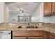 Stylish kitchen with stainless steel sink, granite countertops, and an open view into the living area at 10144 Arbor Run Dr # 157, Tampa, FL 33647