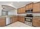Open kitchen boasts stainless steel appliances, granite countertops, and light wood cabinetry at 10144 Arbor Run Dr # 157, Tampa, FL 33647