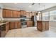 Modern kitchen featuring granite countertops, stainless steel appliances, and tile floors at 10144 Arbor Run Dr # 157, Tampa, FL 33647