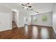 Open living room with wood floors, ceiling fans, stairs, and natural light at 10144 Arbor Run Dr # 157, Tampa, FL 33647