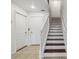 Bright staircase with wooden steps and white railing, offering easy access to upper level at 10144 Arbor Run Dr # 157, Tampa, FL 33647