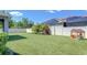 Lush backyard with privacy fence, mature landscaping, solar panels and playset, perfect for outdoor enjoyment at 10868 Breaking Rocks Dr, Tampa, FL 33647