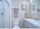 Clean bathroom featuring a glass shower, gray vanity, and beach-themed decor at 10868 Breaking Rocks Dr, Tampa, FL 33647