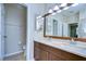 Bathroom with double sinks and wood cabinets providing storage space at 10868 Breaking Rocks Dr, Tampa, FL 33647