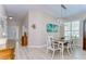 Light-filled dining room features wood floors, coastal decor, and a modern light fixture at 10868 Breaking Rocks Dr, Tampa, FL 33647