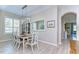 Elegant dining room boasts a modern light fixture, wood floors, and plantation shutters at 10868 Breaking Rocks Dr, Tampa, FL 33647