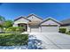 Charming single-story home with well-manicured lawn and three-car garage at 10868 Breaking Rocks Dr, Tampa, FL 33647