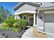 Inviting front entrance with columns, manicured landscaping, and stone accents at 10868 Breaking Rocks Dr, Tampa, FL 33647