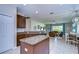 Modern kitchen flows into the living room and has stainless steel appliances and a center island at 10868 Breaking Rocks Dr, Tampa, FL 33647