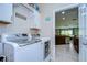 Laundry room featuring a side-by-side washer and dryer with doorway view to kitchen at 10868 Breaking Rocks Dr, Tampa, FL 33647