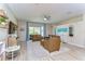Cozy living room with leather furniture, ceiling fan, and sliding glass doors to the lanai at 10868 Breaking Rocks Dr, Tampa, FL 33647
