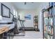 Well-lit office area with exercise equipment, shelving, and plantation shutters at 10868 Breaking Rocks Dr, Tampa, FL 33647