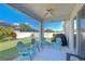 Covered patio with seating area overlooking a fenced backyard with a well-maintained lawn at 10868 Breaking Rocks Dr, Tampa, FL 33647