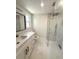 Modern bathroom with marble floors, new vanity, and a spacious glass-enclosed shower at 11210 Yewtree Ave, Port Richey, FL 34668