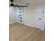 Bedroom featuring a barn door, ceiling fan and closet at 11210 Yewtree Ave, Port Richey, FL 34668