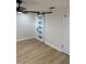 Bedroom featuring a barn door and ceiling fan at 11210 Yewtree Ave, Port Richey, FL 34668