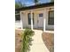 Close up of the freshly painted front door with decorative windows and modern hardware at 11210 Yewtree Ave, Port Richey, FL 34668