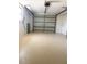 Spacious garage with painted floor and automatic door opener; perfect for parking and storage at 11210 Yewtree Ave, Port Richey, FL 34668