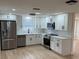 Bright kitchen with white cabinets, stainless steel appliances, and modern fixtures at 11210 Yewtree Ave, Port Richey, FL 34668