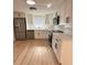 Modern kitchen with stainless steel appliances, white cabinets, and quartz countertops at 11210 Yewtree Ave, Port Richey, FL 34668